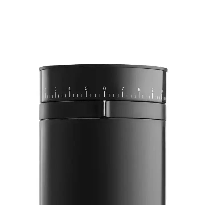 Close-up of black cylindrical coffee grinder with numeric grind size dial from 1 to 10